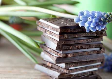 Decorative Stack of Chocolate on wooden board with flower
